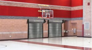 Two commercial rolling steel doors installed inside a gymnasium, a service provided by Overhead Doors Unlimited, LLC in Appleton, WI.