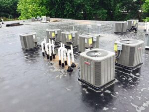 Multiple commercial rooftop air conditioning units installed by R.J. Nelson Co in Council Bluffs, IA.