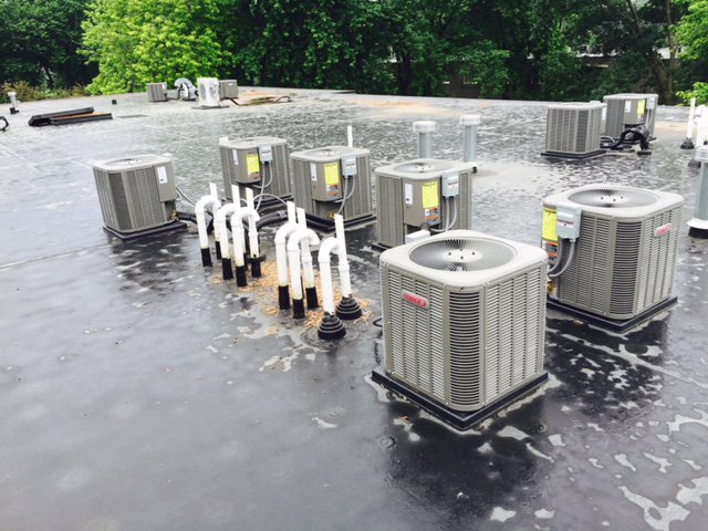 Multiple commercial rooftop air conditioning units installed by R.J. Nelson Co in Council Bluffs, IA.