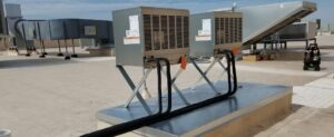 Multiple commercial rooftop evaporative coolers or HVAC units on a building in Phoenix, AZ, maintained by Kade Mechanical.