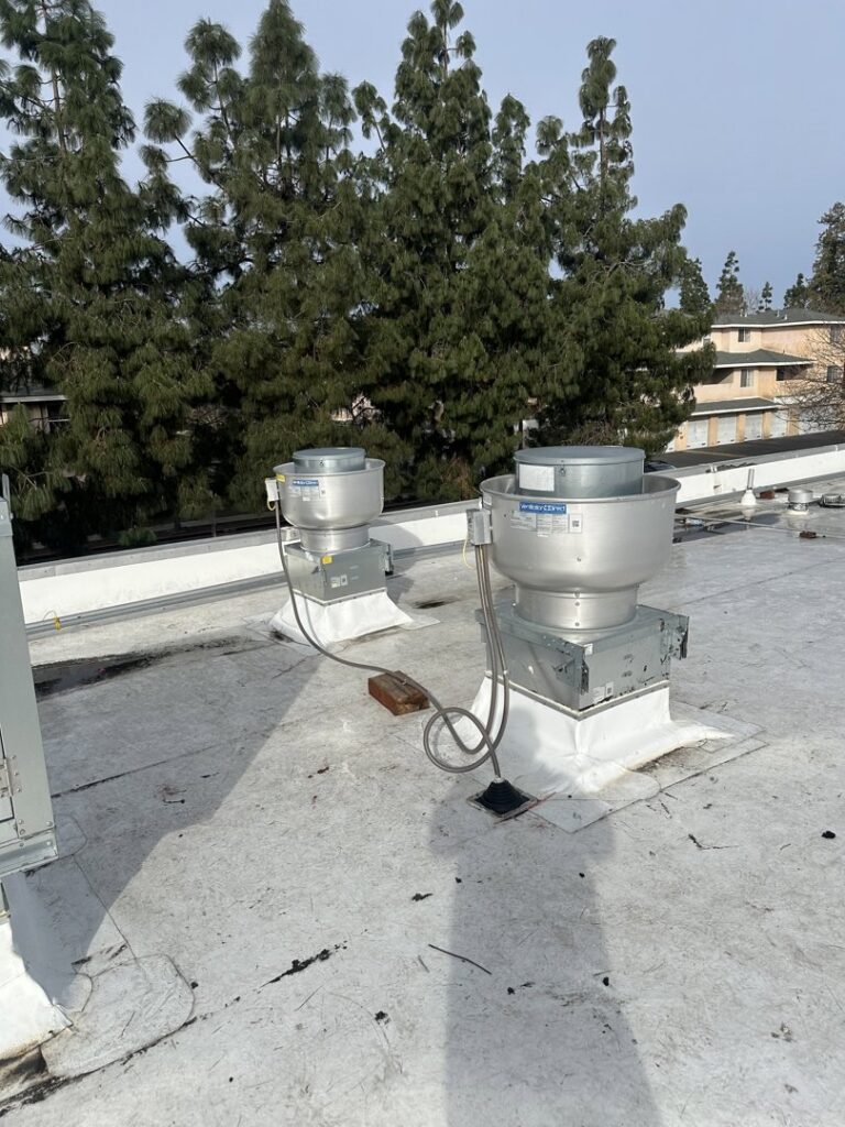 Two commercial rooftop exhaust fans or ventilation units installed by DeHart Plumbing, Heating, & Air in Sparks, NV.