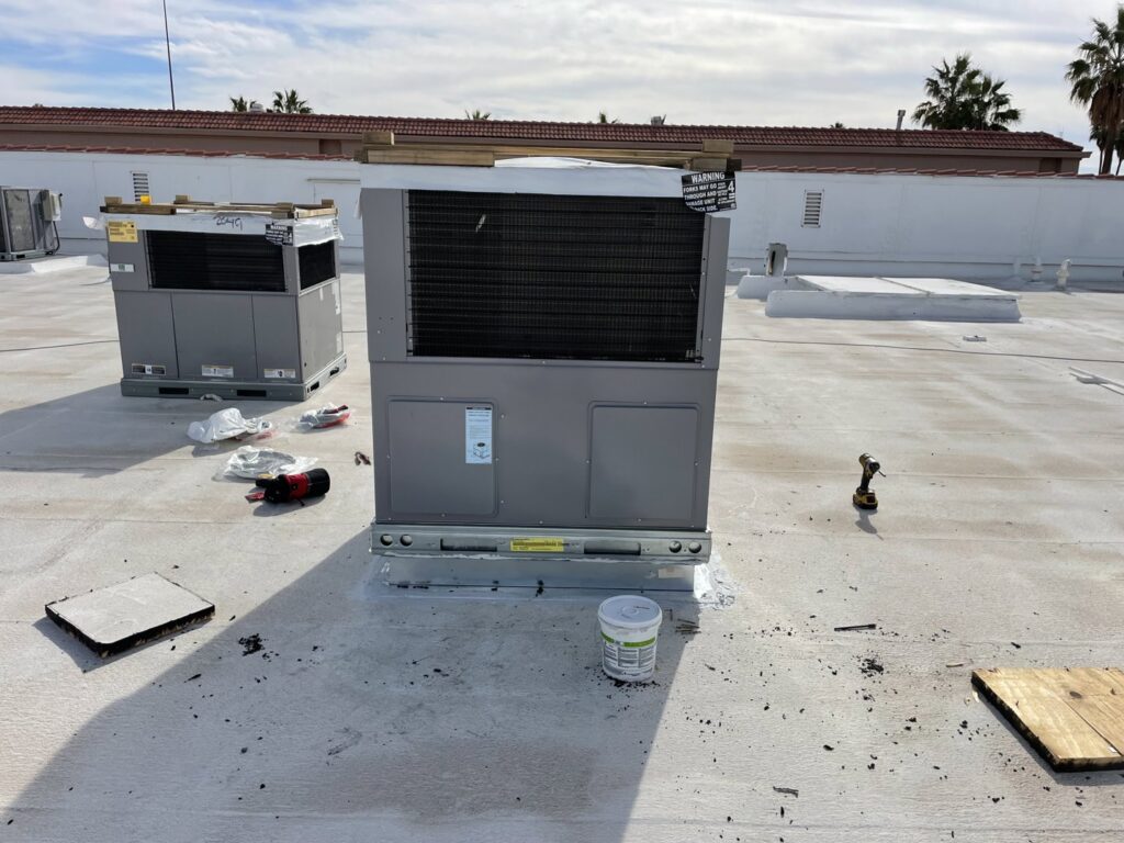 Commercial rooftop HVAC units being installed or serviced by LEWIS AIR LLC in Mesa, AZ.