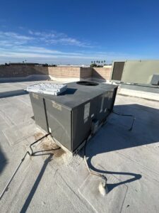 A large commercial rooftop HVAC package unit under a clear blue sky, installed by Kade Mechanical in Phoenix, AZ.