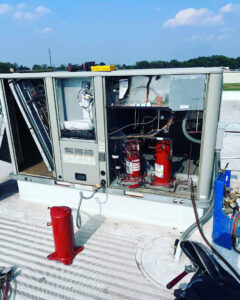 Interior components of a commercial rooftop HVAC unit being repaired by A & A Air Conditioning & Heating in Little Rock, AR.