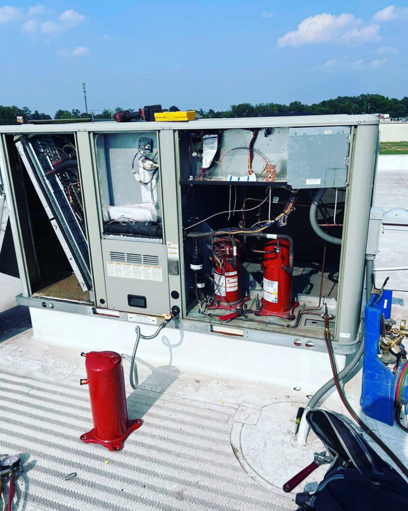 Interior components of a commercial rooftop HVAC unit being repaired by A & A Air Conditioning & Heating in Little Rock, AR.