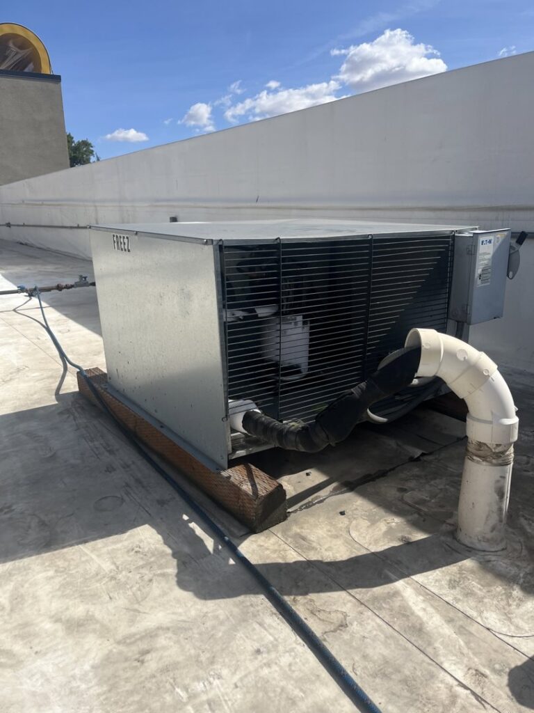 A large commercial rooftop HVAC system with ductwork connections, maintained by Hvaclife in Minneapolis, MN.