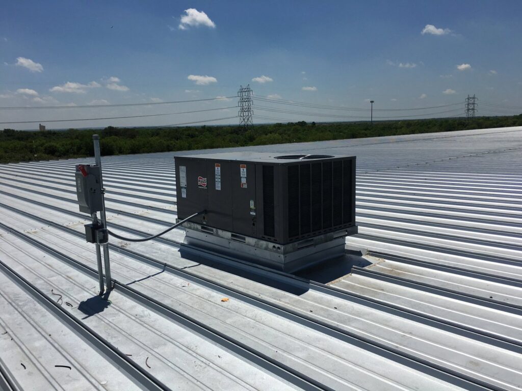 A commercial rooftop HVAC system with electrical connections, installed by Premier Comfort Service Company in San Antonio, TX.