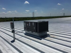 A commercial rooftop HVAC system with electrical connections, installed by Premier Comfort Service Company in San Antonio, TX.