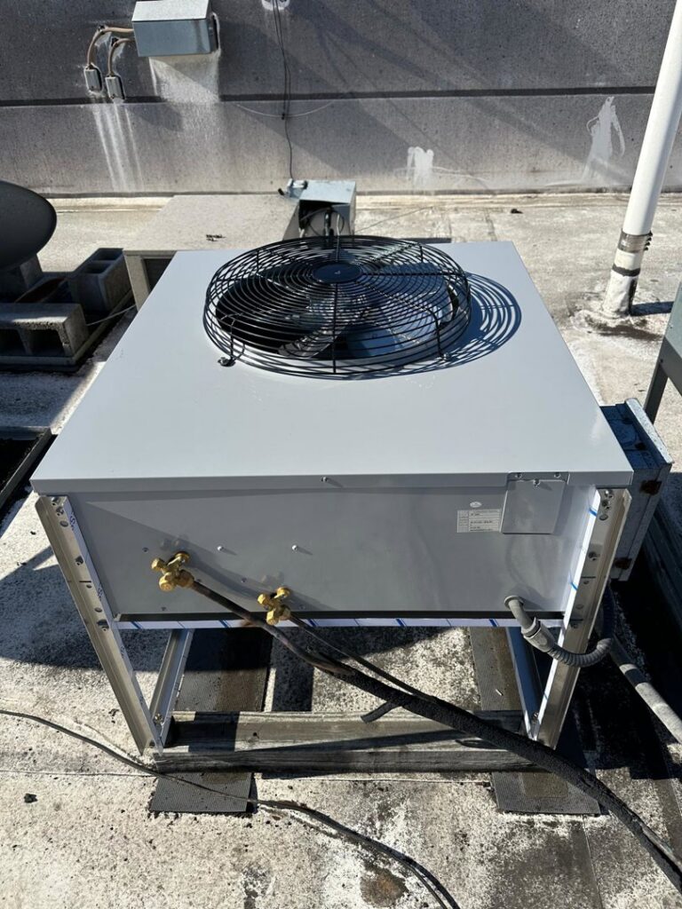 A commercial rooftop HVAC unit with a fan visible on top, installed or serviced by Air Casablanca Heating & Cooling in Myrtle Beach, SC.