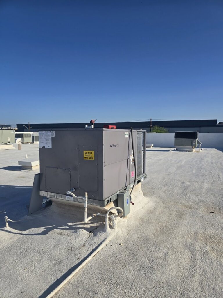 A commercial rooftop HVAC unit installed on a white roof, serviced by Az AC and Heat Services in Queen Creek, AZ.
