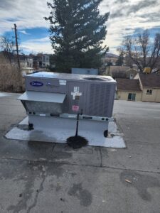 A commercial rooftop Carrier WeatherMaster HVAC unit installed by D & D Heating & Air in Brighton, CO.