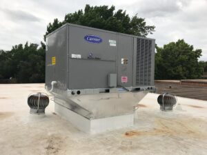 A large Carrier WeatherMaster commercial rooftop HVAC unit installed by Prudhom Mechanical LLC in Edmond, OK