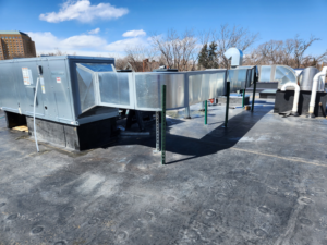 A large commercial rooftop HVAC unit with extensive ductwork installed by EPCTL Heating and Cooling in Byers, CO.