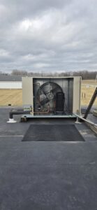 A commercial rooftop HVAC unit showing the fan and internal components by Pike Mechanical in Vevay, IN.
