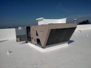 A newly installed commercial rooftop HVAC unit on a white roof by Benck Mechanical Inc in Somerset, WI.