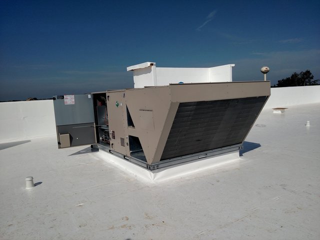 A newly installed commercial rooftop HVAC unit on a white roof by Benck Mechanical Inc in Somerset, WI.