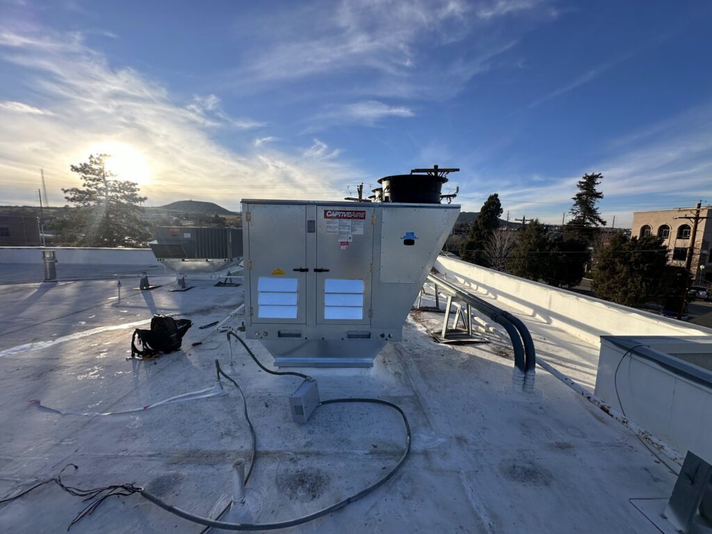A large commercial rooftop HVAC unit installed on a building by CHAMPS Heating&Air in Denver, CO