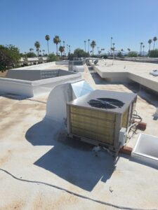 A commercial rooftop HVAC unit with ductwork installed on a flat roof by Krahn and Son Mechanical in Glendale, AZ.