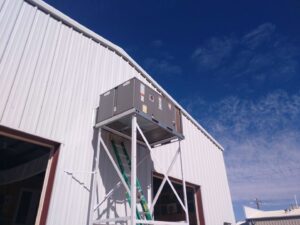 A commercial rooftop HVAC unit installed on a stand by Raytech Refrigeration, Heating & Cooling in Alamogordo, NM.