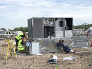 R.J. Nelson Co technicians installing a large commercial rooftop HVAC unit in Council Bluffs, IA.