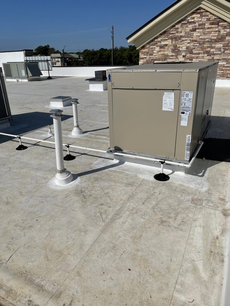 A large commercial rooftop HVAC unit on a flat roof, installed and maintained by Jupitair in Frisco, TX.