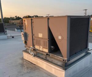 A commercial rooftop HVAC unit at sunset, installed by Wright Heating and Air in Louisville, KY.