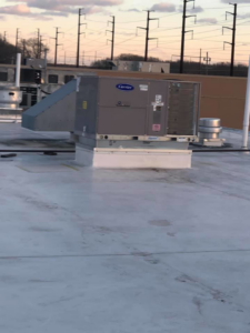 A commercial rooftop HVAC unit with connected ductwork, installed by Air Quality, LLC in Cranston, RI