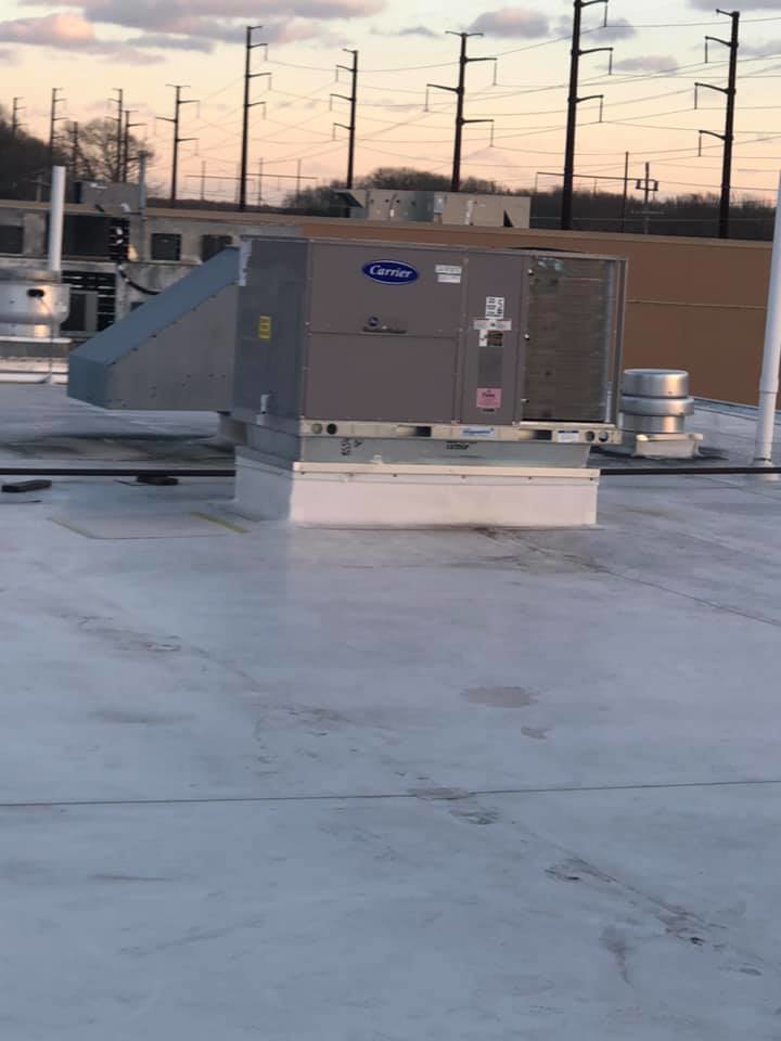 A commercial rooftop HVAC unit with connected ductwork, installed by Air Quality, LLC in Cranston, RI