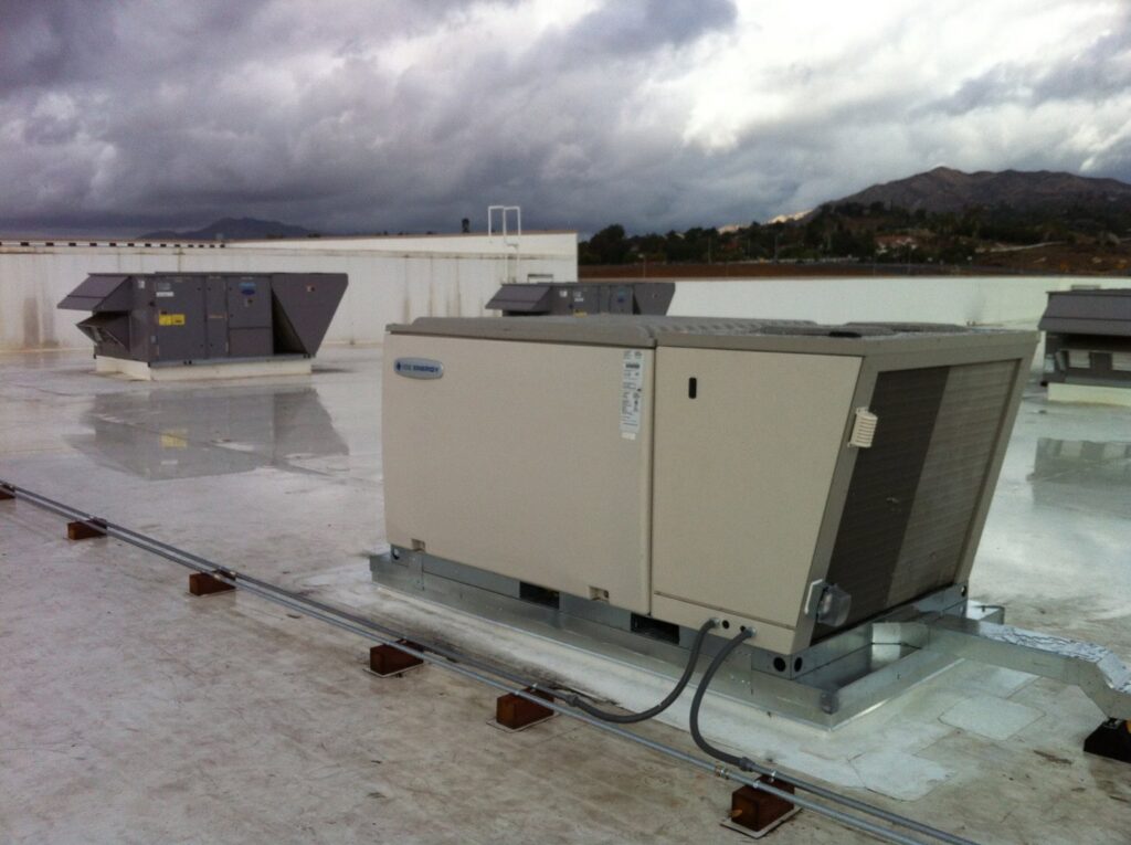 Multiple large commercial rooftop HVAC units installed on a building roof by 1st Team Air Conditioning in Anaheim, CA
