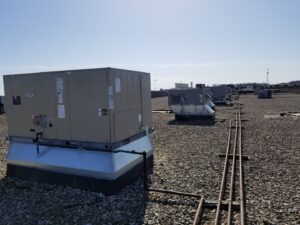 Multiple commercial rooftop HVAC units on a building serviced by Debbie's Heating and Cooling in South Bend, IN.