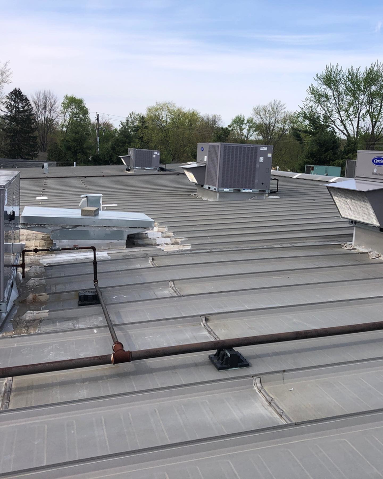 Multiple commercial rooftop HVAC units installed by Inspired Heating & Cooling, Electric, Roofing, Repair LLC in Columbus, OH.