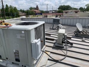 Multiple commercial rooftop HVAC units and mini-split outdoor units installed by Get RiTe A/C & Heating in Madisonville, LA.