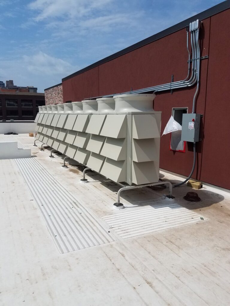Commercial rooftop HVAC units installed by Polar Aire Heating & Cooling on a building in Olathe, KS