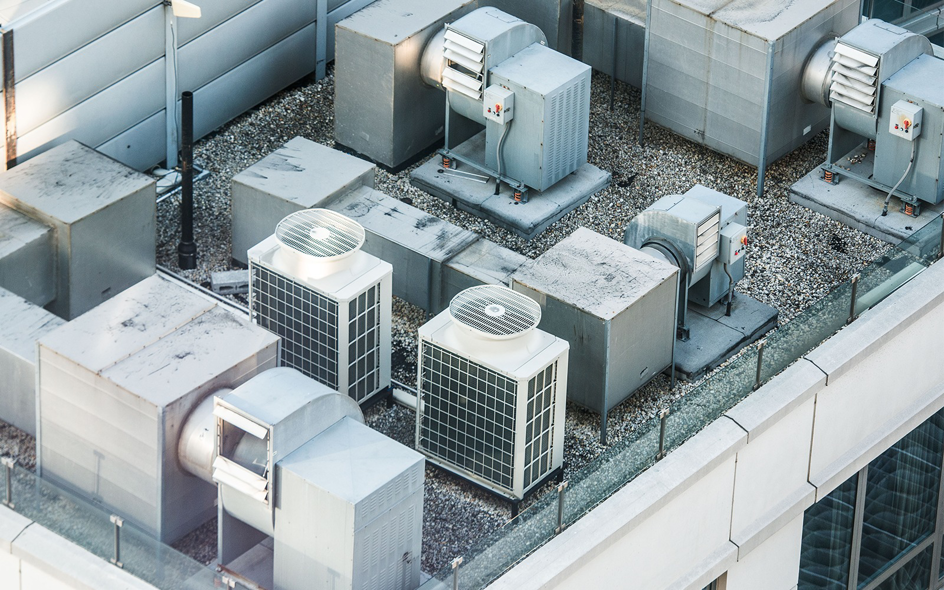 An aerial view of multiple commercial rooftop HVAC units and ductwork installed by Service2.0 in Toledo, OH.