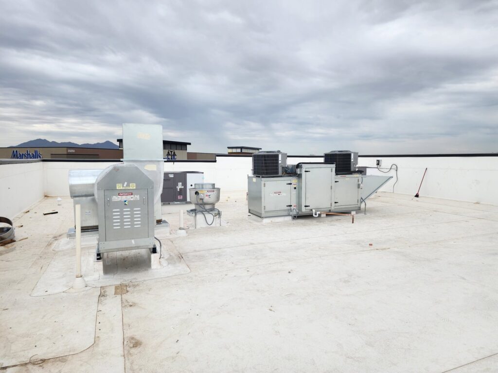 Multiple commercial rooftop HVAC units installed on a large building, demonstrating commercial HVAC services by State 48 Home Comfort LLC in Peoria, AZ.