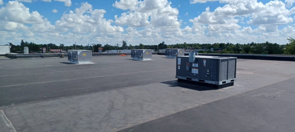 Multiple commercial rooftop HVAC units on a building serviced by Tornado Heating and Air in Tulsa, OK.