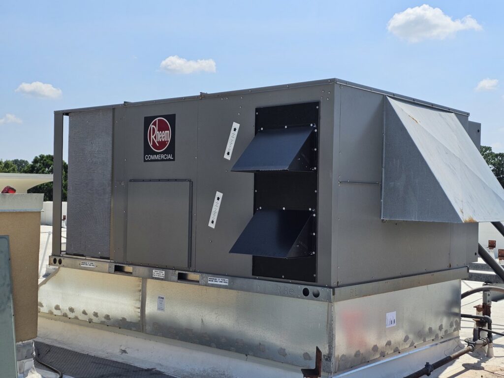 A large commercial Rheem HVAC unit installed on a rooftop by Peak Seasons HVAC in Raleigh, NC.