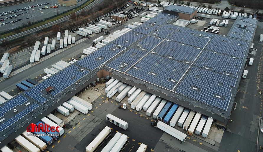 Aerial view of a commercial rooftop solar panel installation by Altec Building Systems in Point Pleasant, NJ