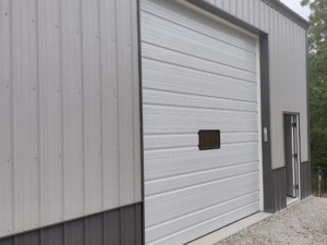 Close-up of a newly installed commercial sectional garage door by Horton & Hill Garage Door Specialists LLC in Sapulpa, OK.
