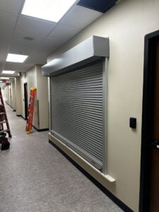 A commercial security roll-up door installed in an interior hallway by Geaux Overhead Door in West Monroe, LA.