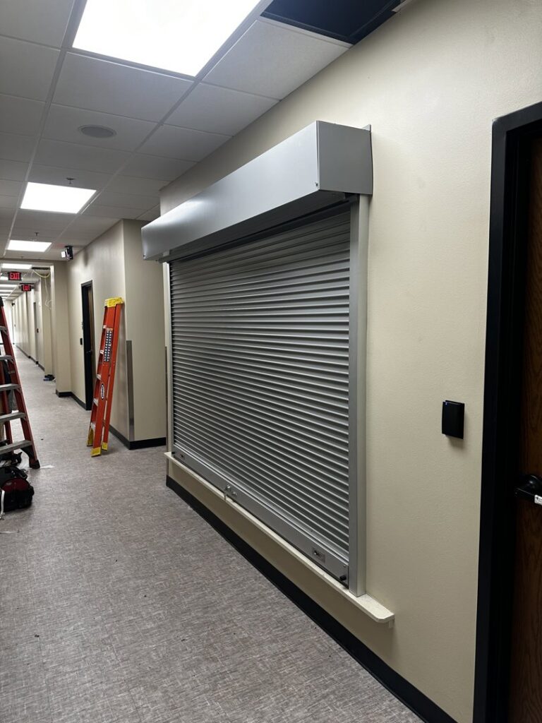 A commercial security roll-up door installed in an interior hallway by Geaux Overhead Door in West Monroe, LA.