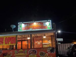 A brightly lit commercial sign for Taqueria San Andres, showcasing sign lighting repair or installation by Quistian Lighting in Arlington, TX
