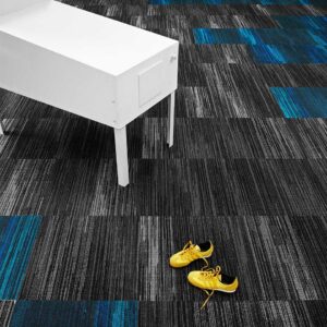 A commercial space showcasing modern black and blue striped carpet tiles, installed by Eastpointe Interiors in Caledonia, MI.