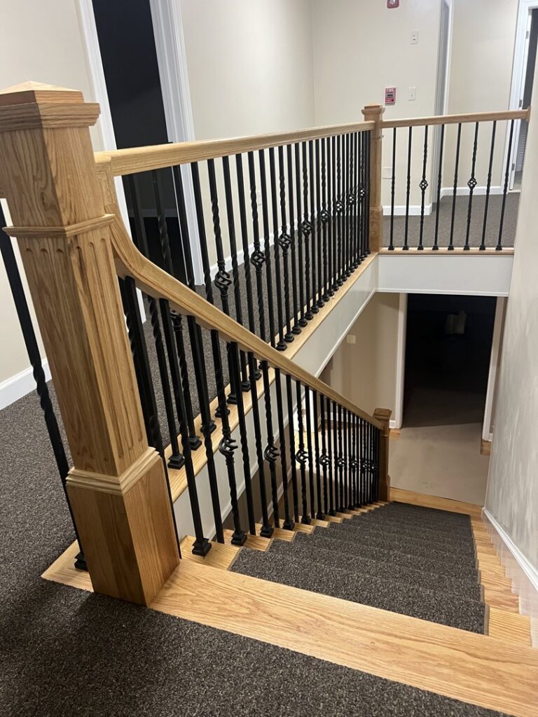 A commercial staircase with durable dark gray carpet installed by Carpet King and Flooring in Myrtle Beach, SC.