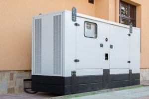 A large commercial standby generator installed outside a building by Genesys Electrical Contractors in Dallas, TX