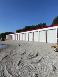 A long row of newly installed white roll-up doors for commercial storage units by Garage Door Repair Company, LLC in Pueblo, CO.