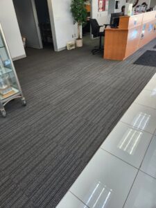 Modern striped carpet tiles installed in a commercial office space by Carpet Center in Nashua, NH.