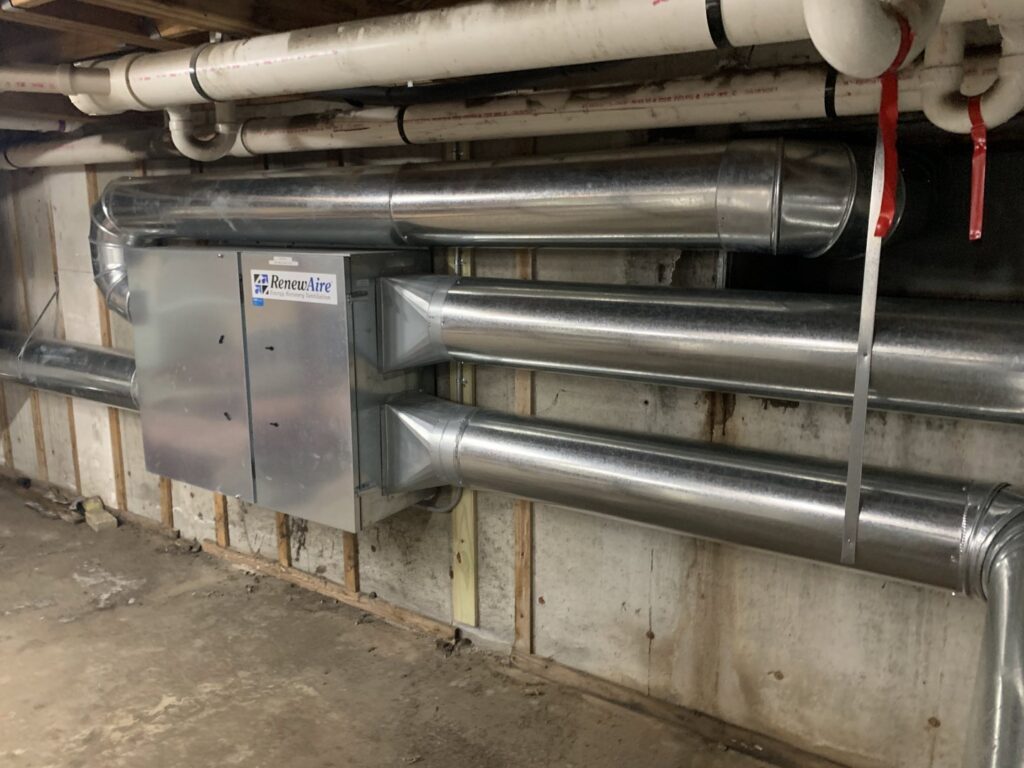 A commercial ventilation system with large metal ductwork and a RenewAire unit installed by Elite Mechanical in Manchester, NH.