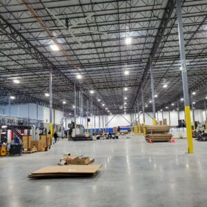 Interior view of a large commercial warehouse with industrial lighting, showcasing electrical installation by York Electrical Services in York, PA.
