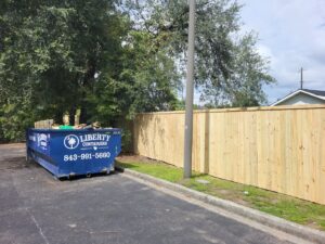 A long wooden privacy fence installed for a commercial property by JB FENCE Brothers company llc in North Charleston, SC.